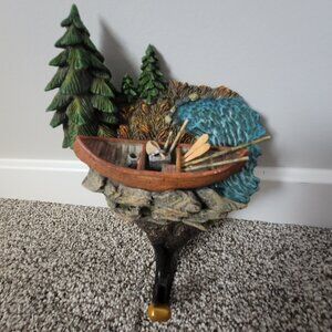 Wall hanger decor. Cabin and canoe